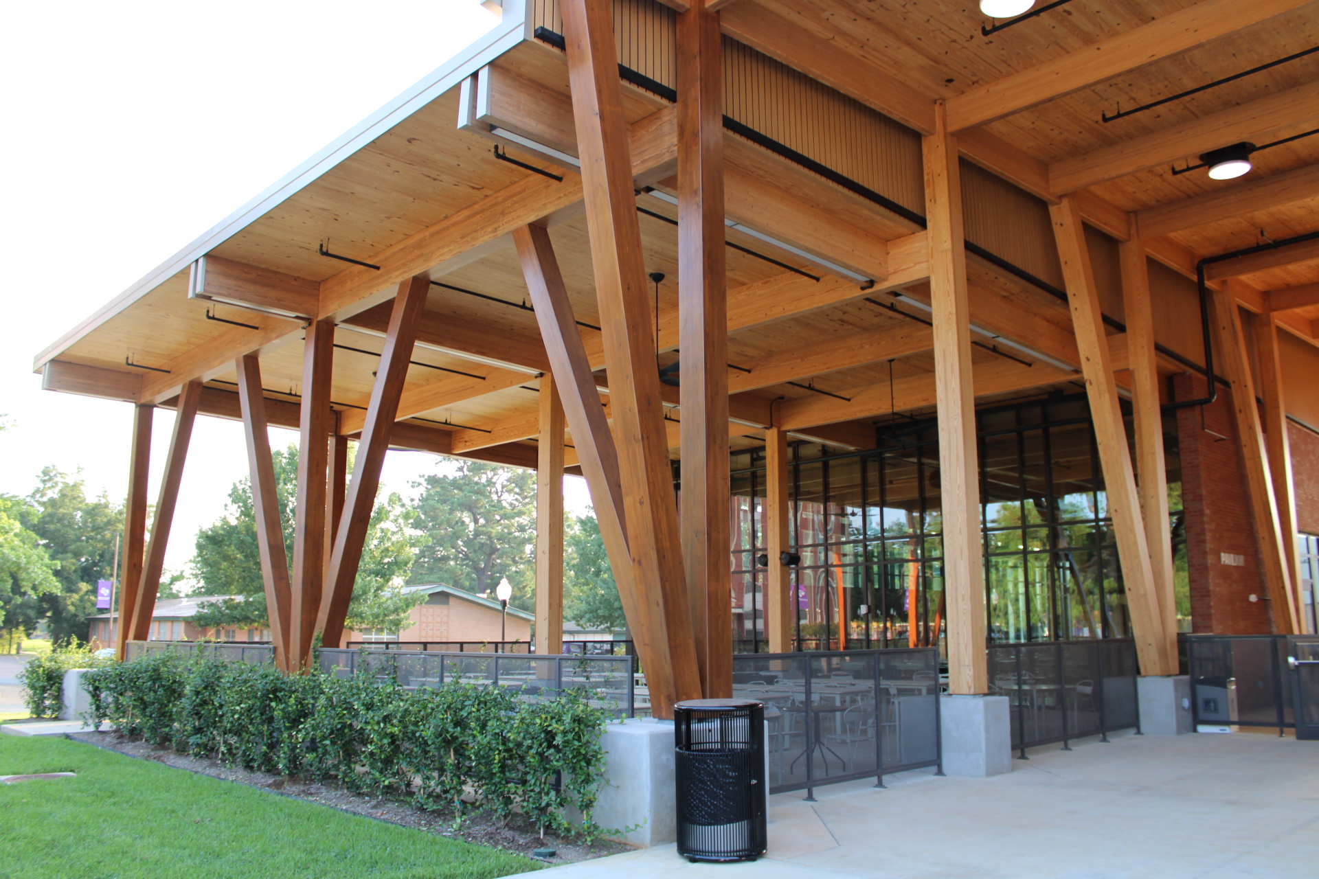 Detail view of modern glulam (glued laminated timber) structural elements used in contemporary architectural construction, showing engineered wood beams in a building framework.