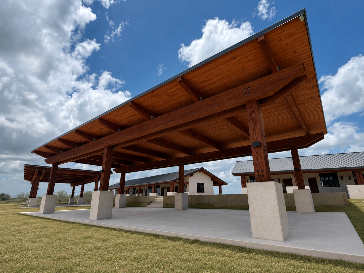 Photo 3 1 Mass timber pavilion with exposed glulam beams and columns supported by concrete bases at a commercial construction site.